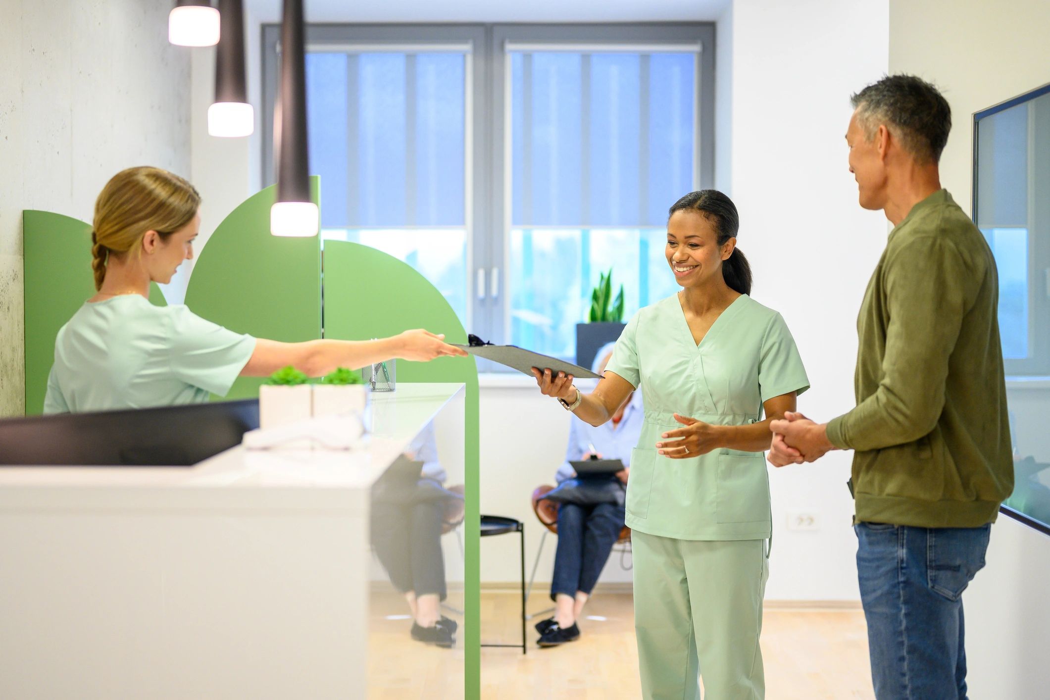 Clinic staff helping a patient with forms